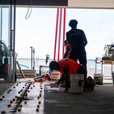Tiler setting out tiles on a balcony