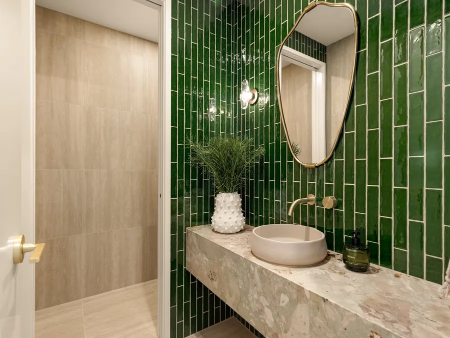 Ensuite with deep green gloss subway feature tiles and a stone vanity